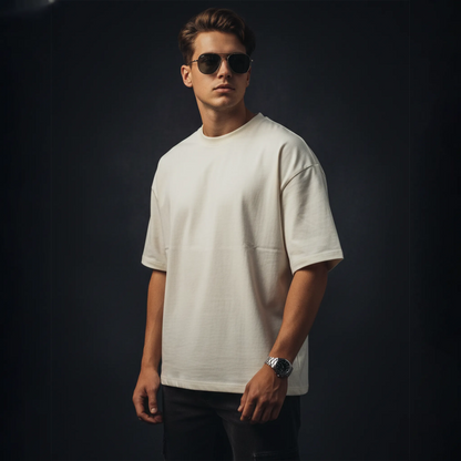 Man wearing a white t-shirt and sunglasses against a dark background