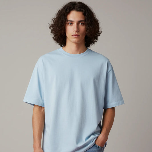 Person wearing a light blue t-shirt and jeans against a plain background
