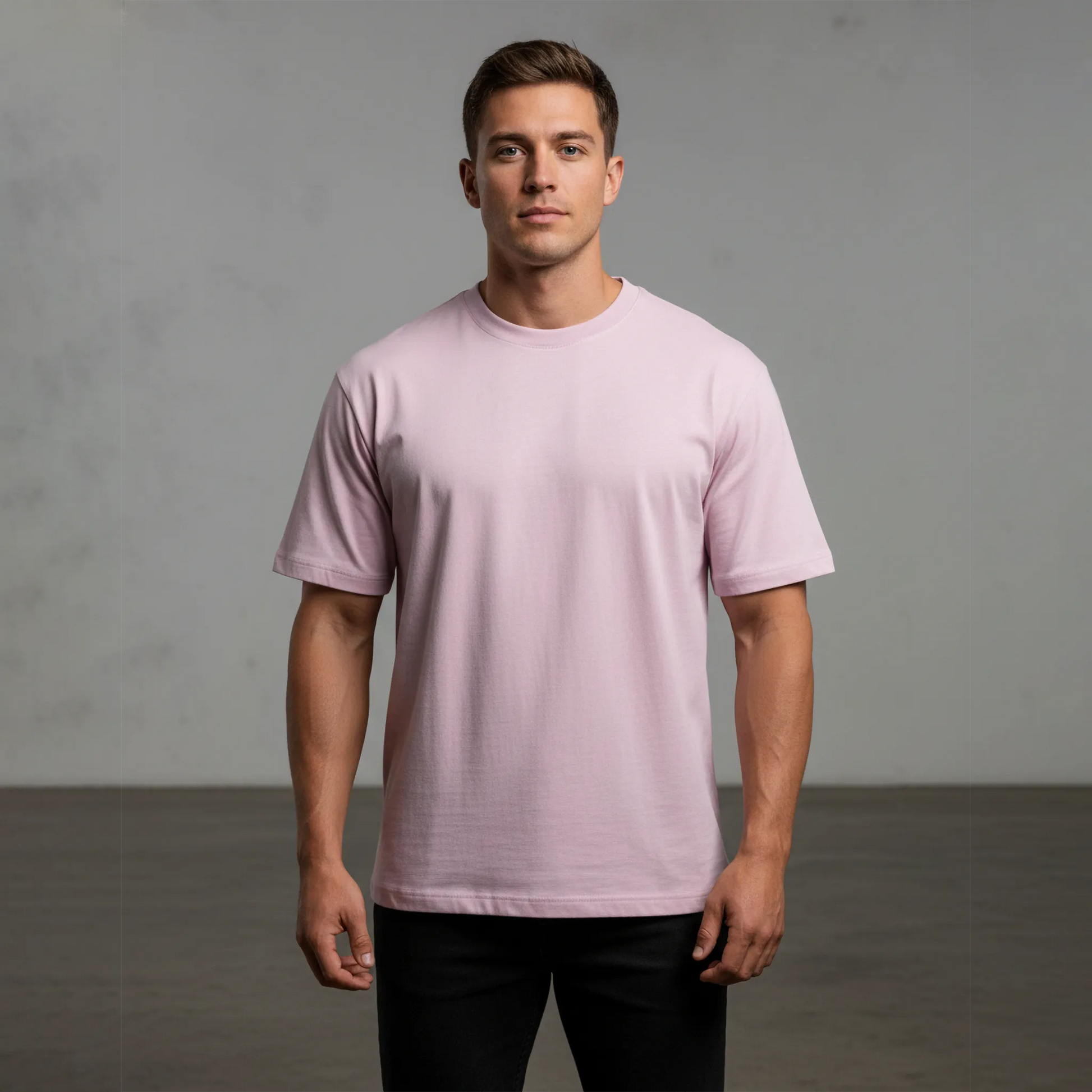 Man wearing a light pink t-shirt against a gray background
