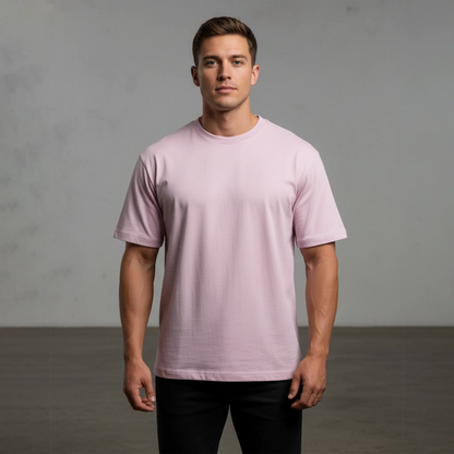 Man wearing a light pink t-shirt against a gray background