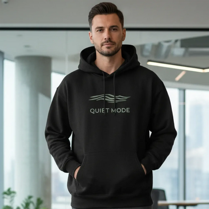Man wearing a black hoodie with 'Quiet Mode' text in an indoor setting
