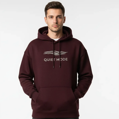 Man wearing a maroon hoodie with 'Quiet Mode' text on a white background