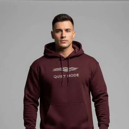 Man wearing a maroon hoodie with 'Quiet Mode' text on a gray background