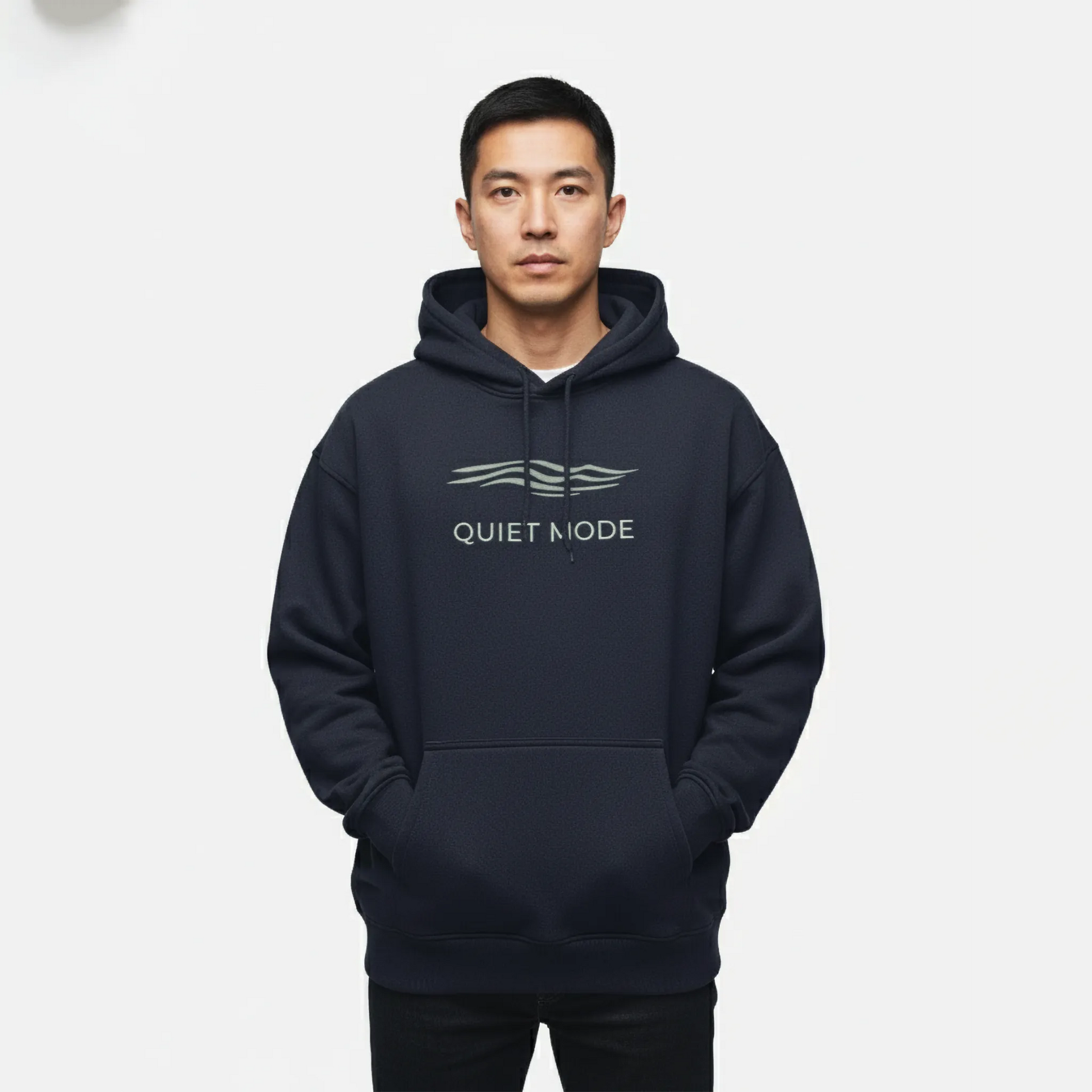 Person wearing a navy hoodie with 'Quiet Mode' text on a white background