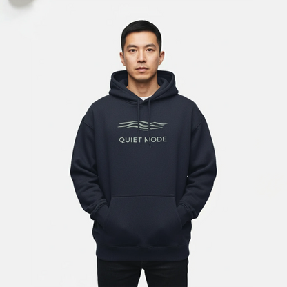 Person wearing a navy hoodie with 'Quiet Mode' text on a white background