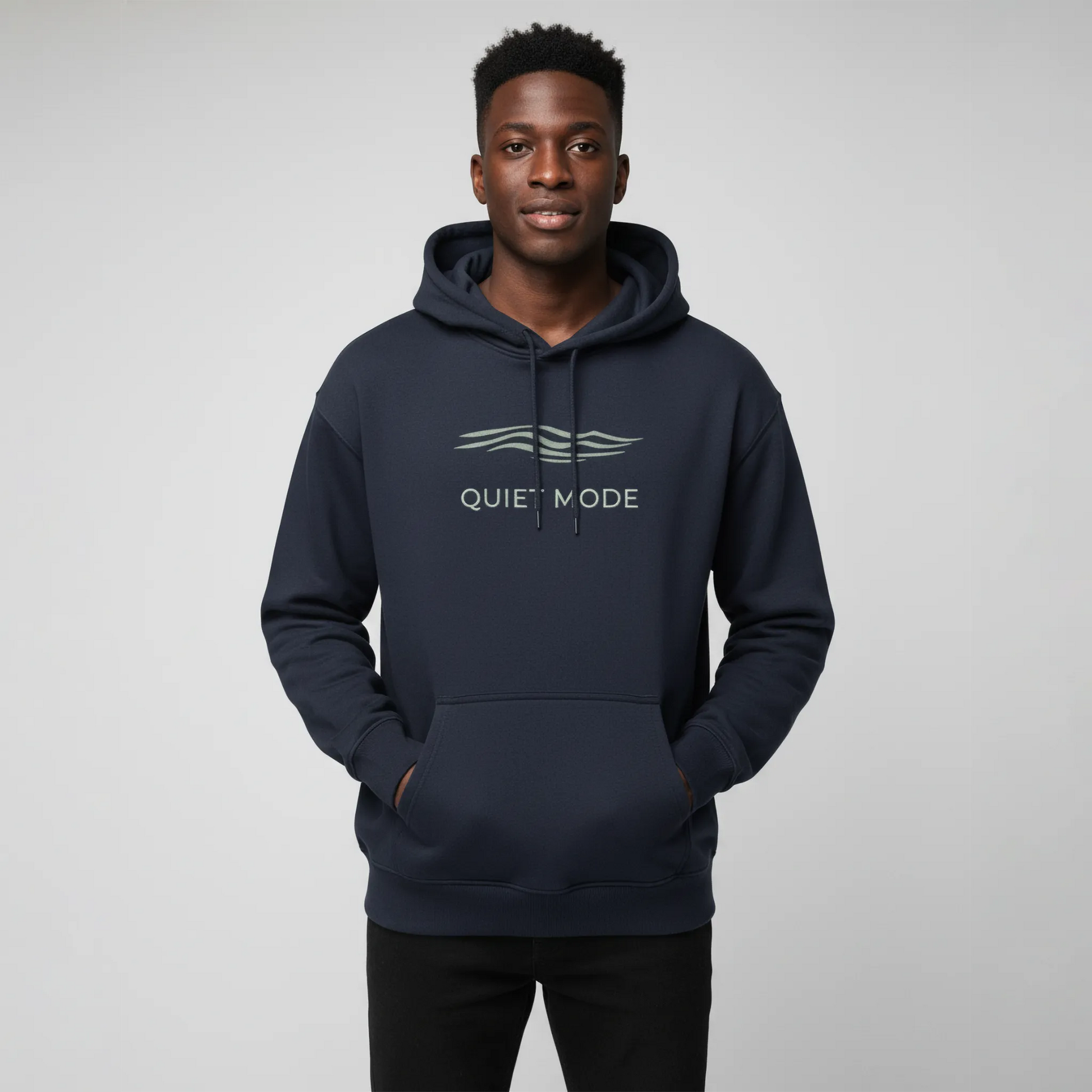 Person wearing a navy hoodie with 'QUIET MODE' text on a gray background
