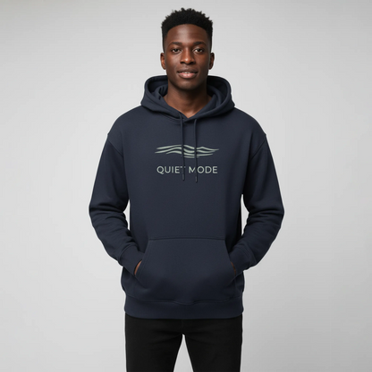 Person wearing a navy hoodie with 'QUIET MODE' text on a gray background